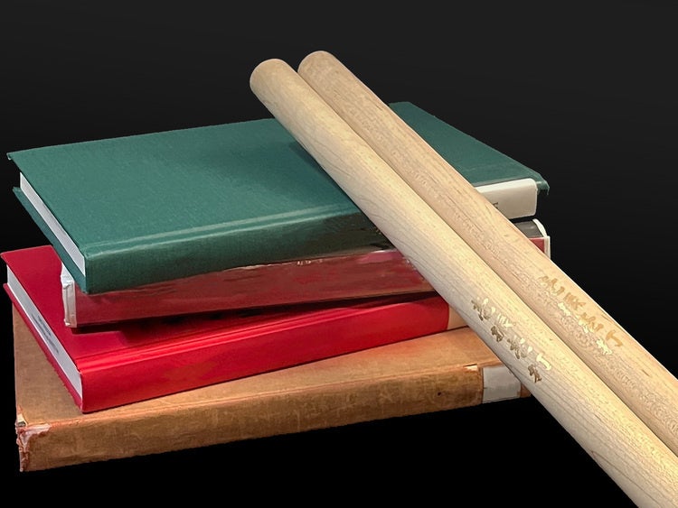 Drumsticks on books