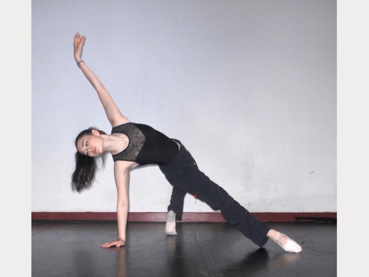 Dancer posing with one hand on the ground