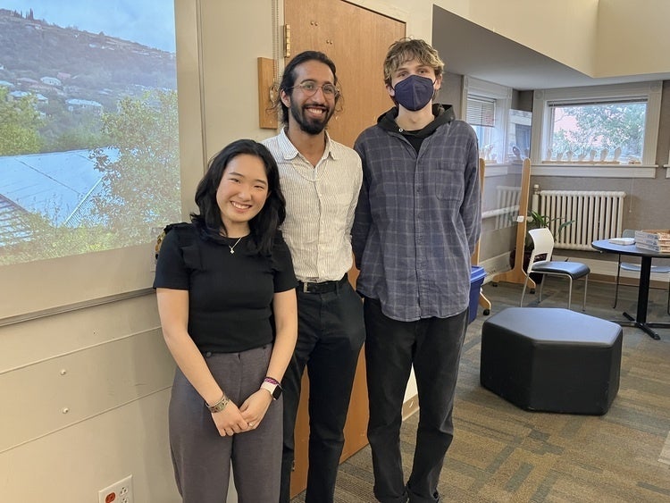three people standing together for a photo