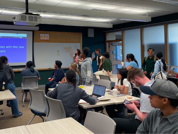 Students gather in K100 for a trivia study break with snacks. 