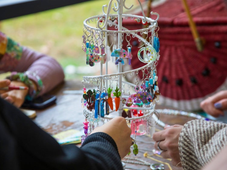 rack of earrings being sold at previous makers market