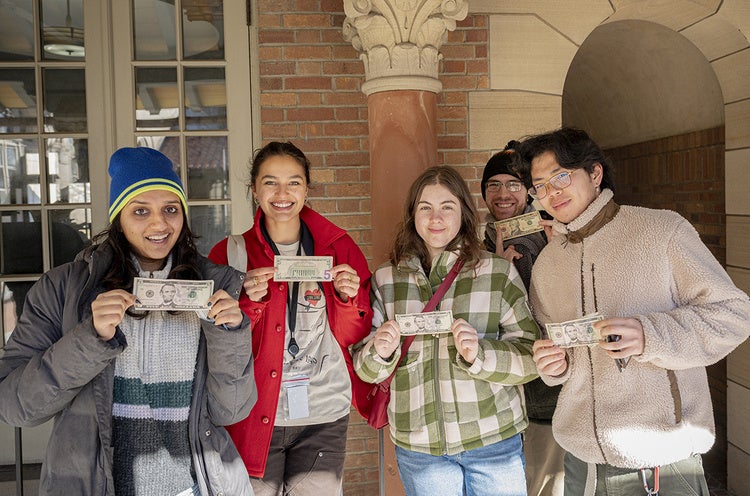 Students at Art Rental pose with their $5 bills.
