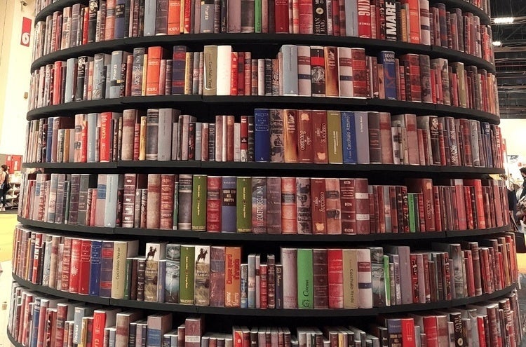 tall, round bookshelf full of books