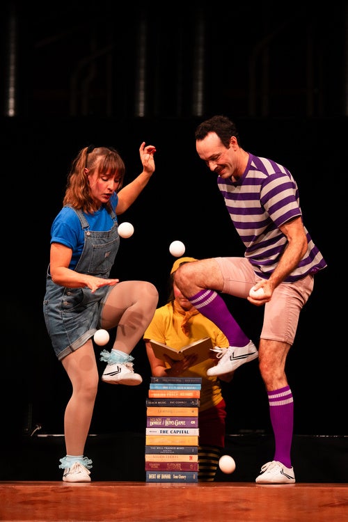 Two performers juggling onstage