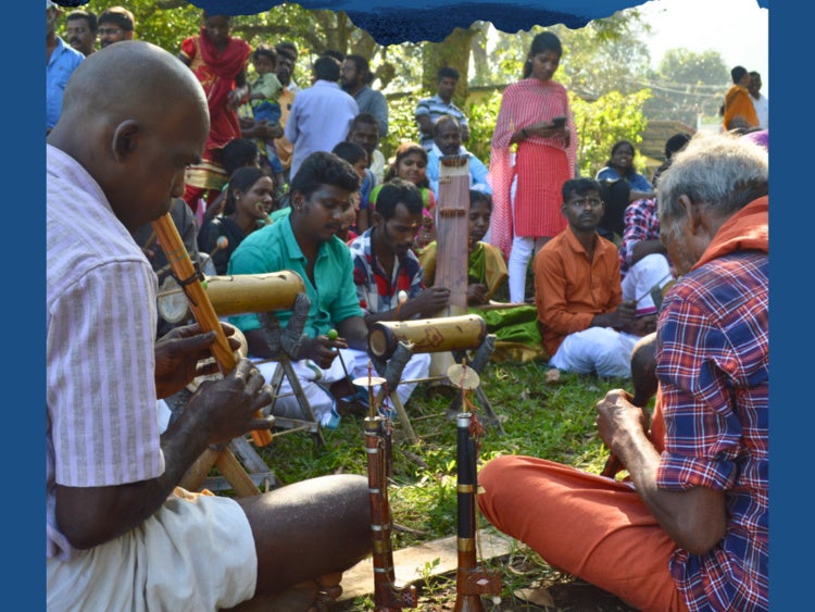 Group of people sitting together making instruments