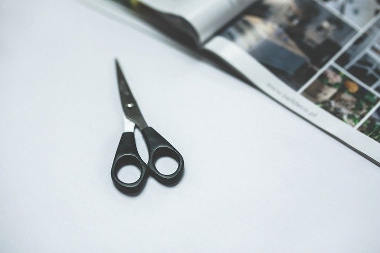 Scissors beside a magazine