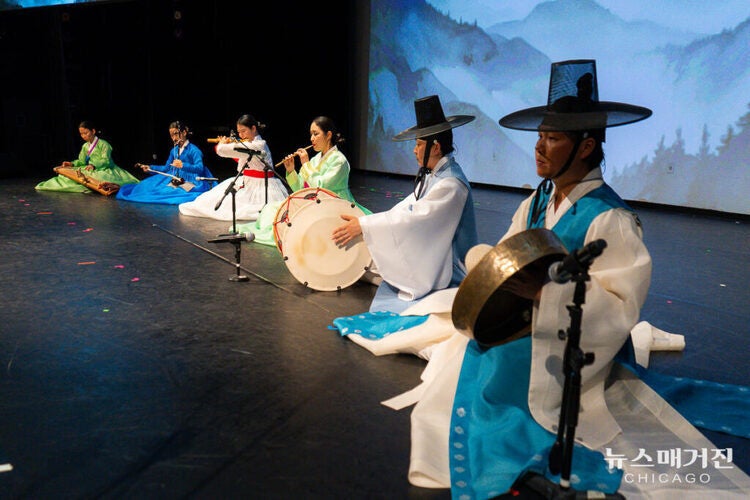 Six Korean folk musicians perform on stage