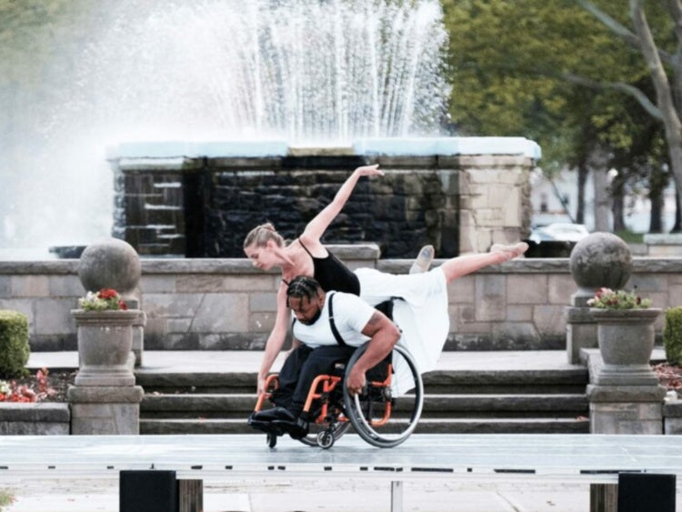 Janet Dziak dancing with partner in front of water feature in Lakeview park in Lorain, Ohio
