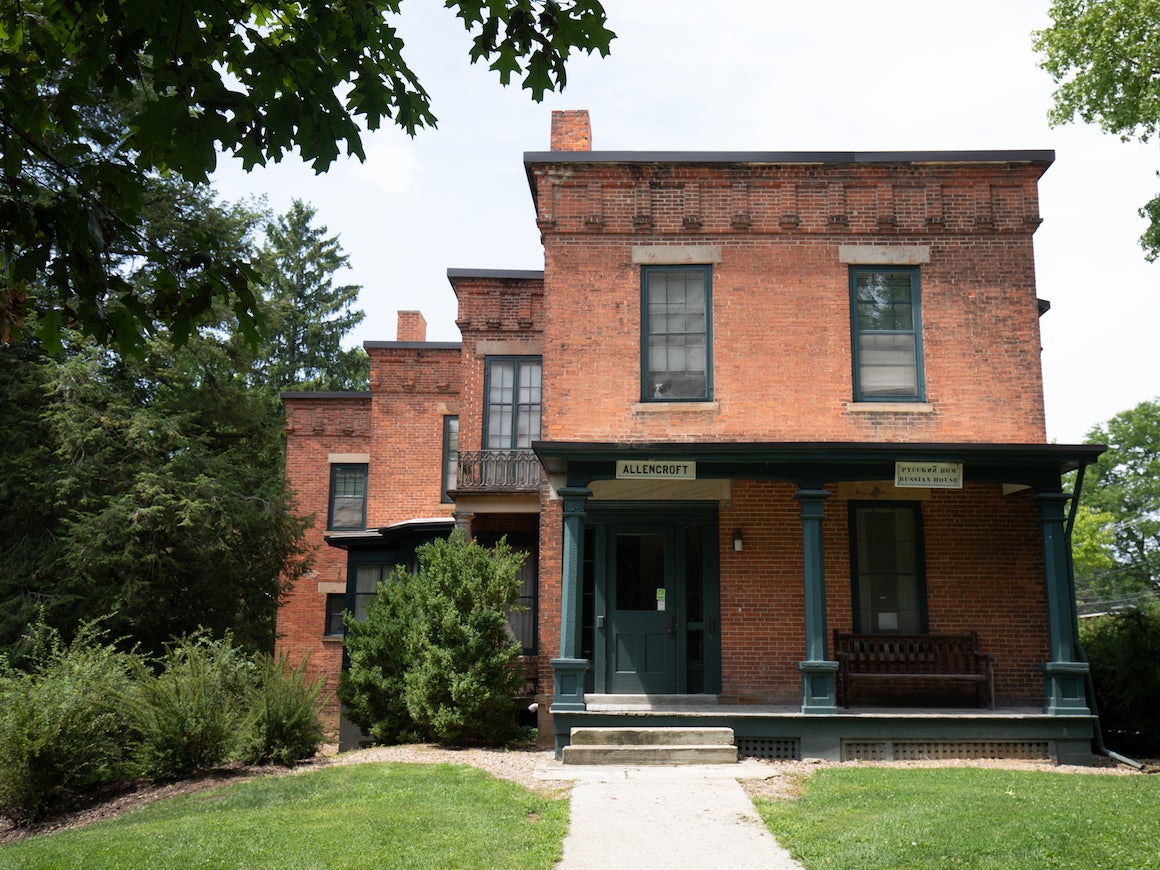 front outside view of small brick house with extended front porch.