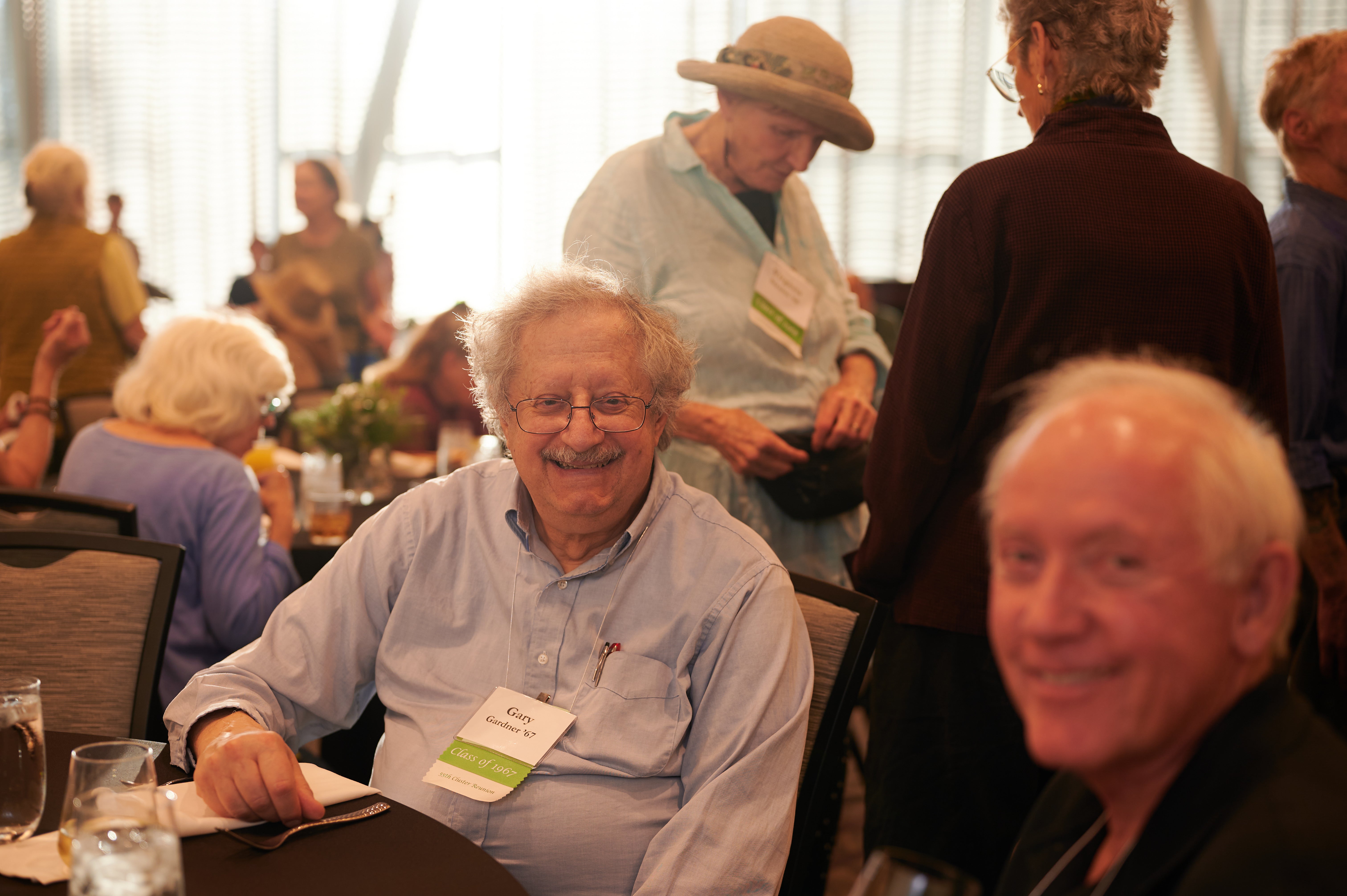 A smiling man at a banquet table.