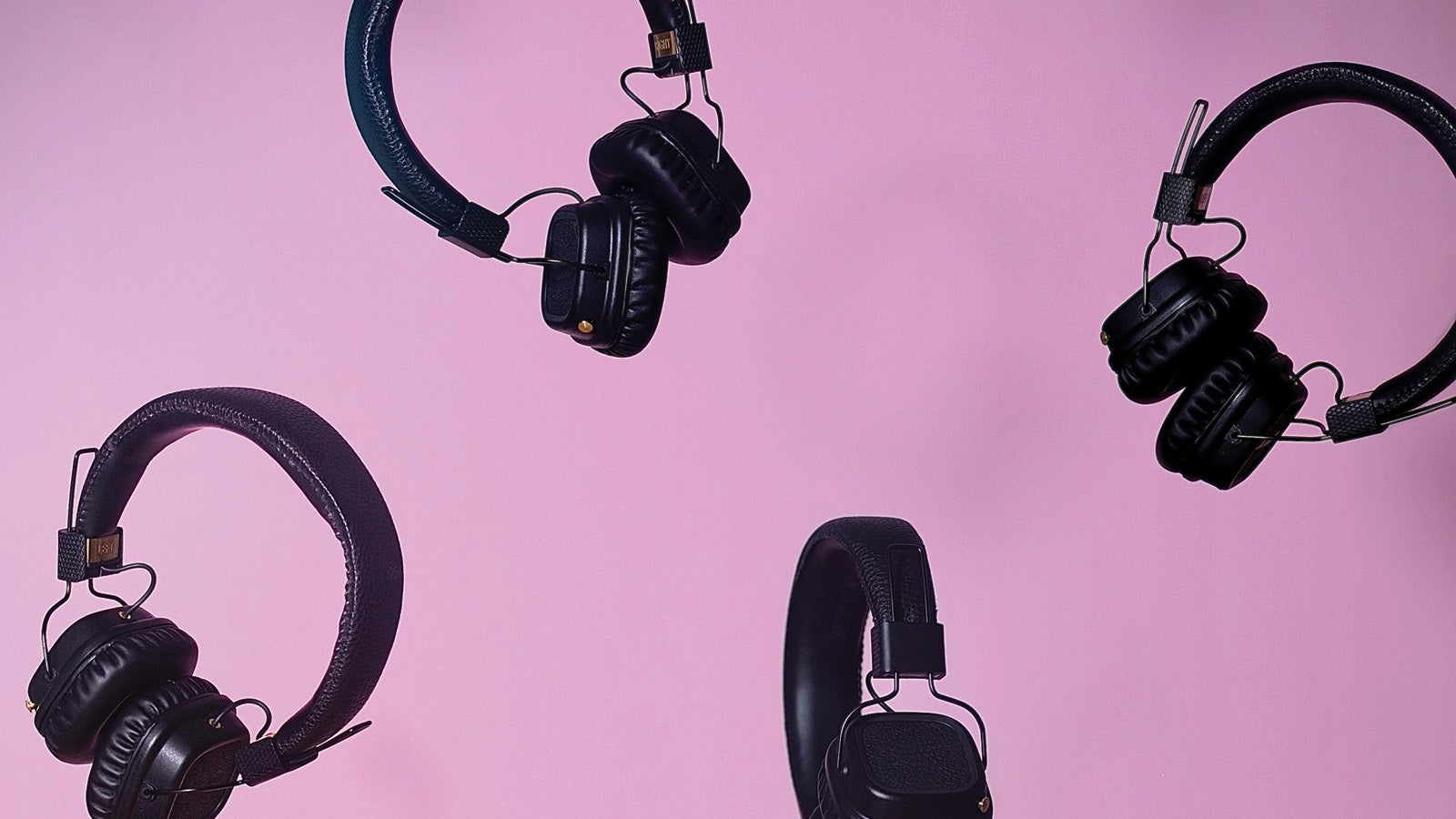 Four sets of headphones on an abstract background