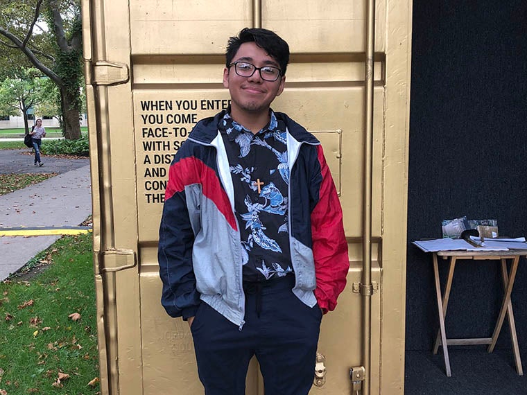student stands in front of Oberlin_Portal