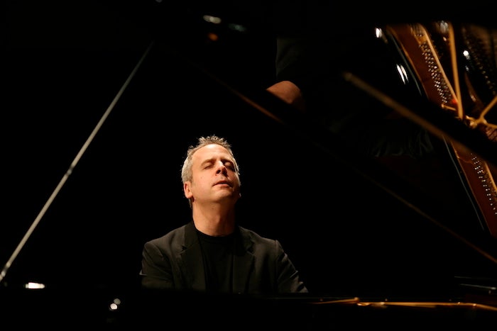 Pianist Jeremy Denk performing on the piano 