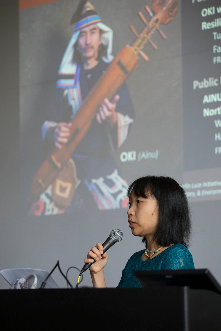 Woman standing at podium.