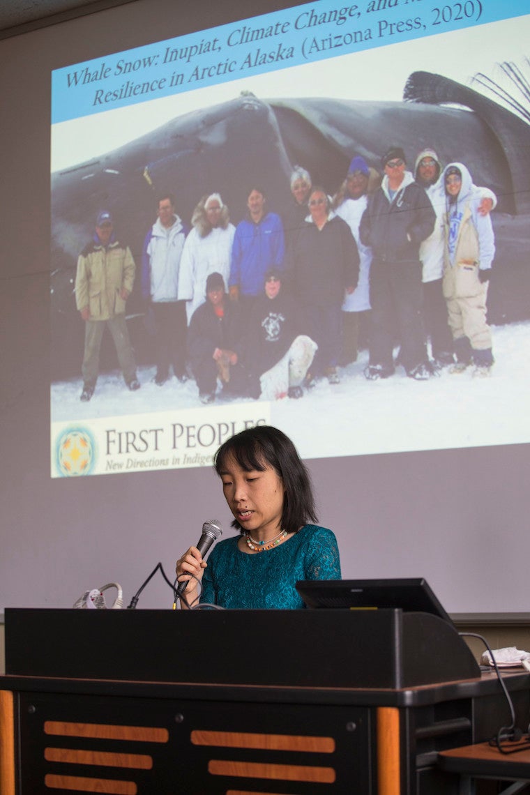 Woman standing at podium.