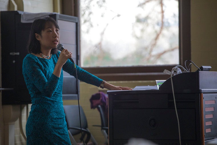 Woman speaking into microphone.