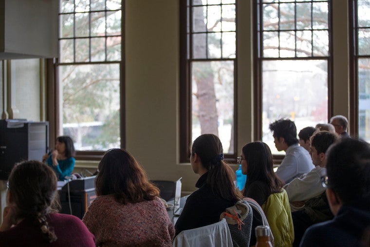 People seated in classroom. 