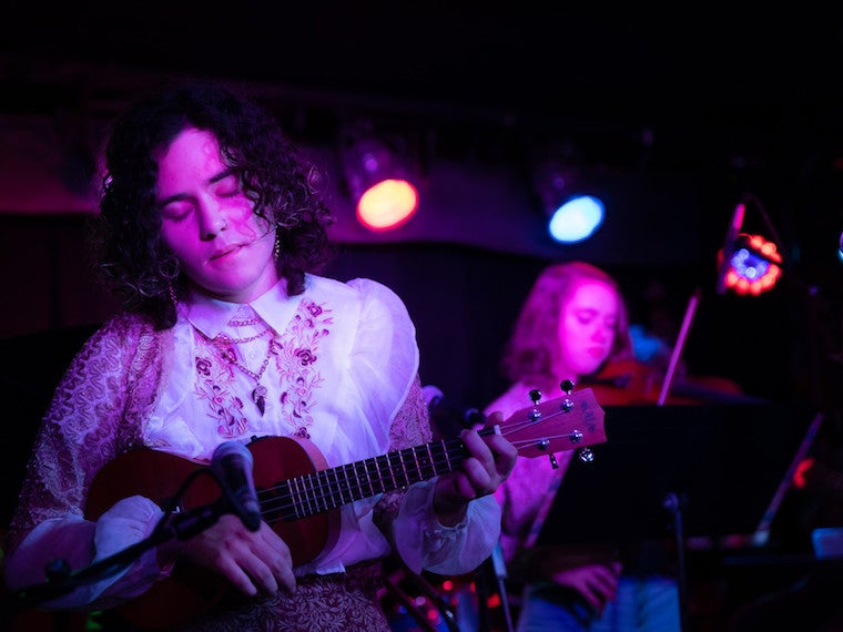 A girl playing a guitar