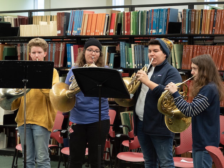 Students playing French horns,