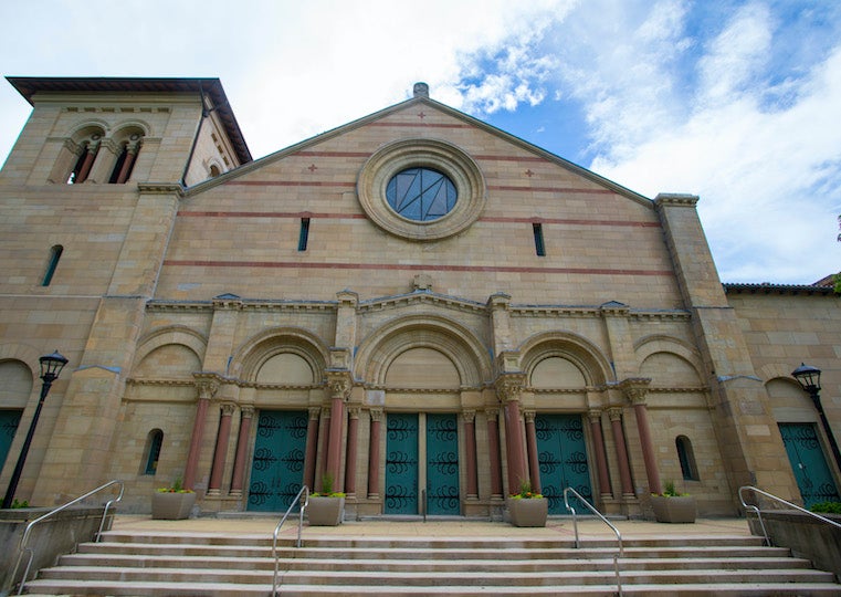 A large chapel with a round window and bell tower