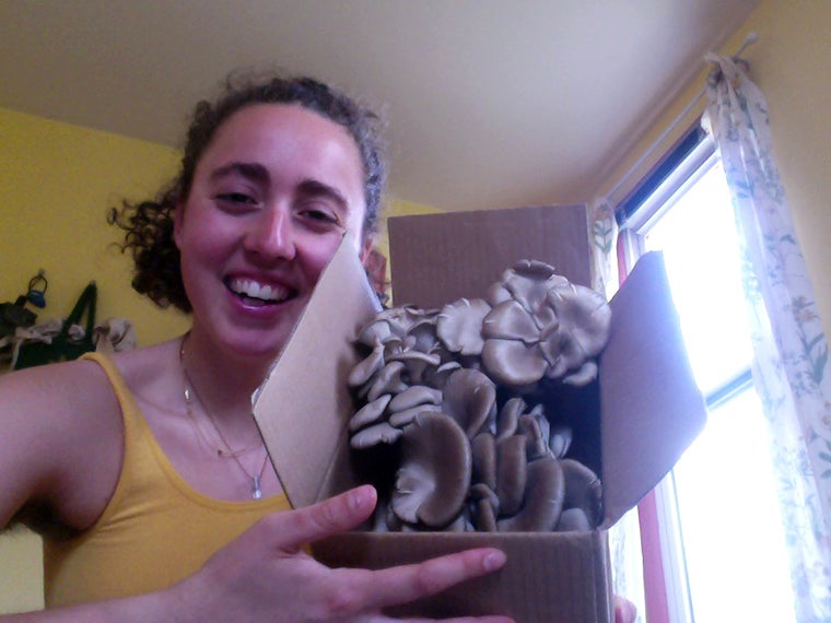 Woman holding plant specimens.