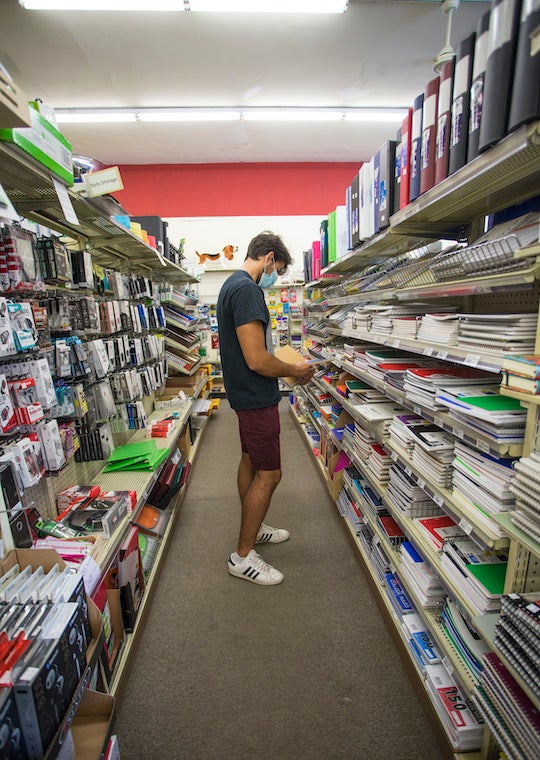 A student shops in the school supplies section of a store 
