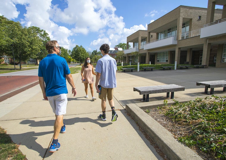 A parent and son take a guided campus tour.