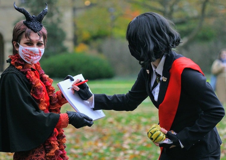 Two girls dressed in Halloween costumes.