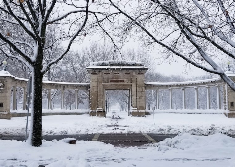 A memorial arch covered in snow.