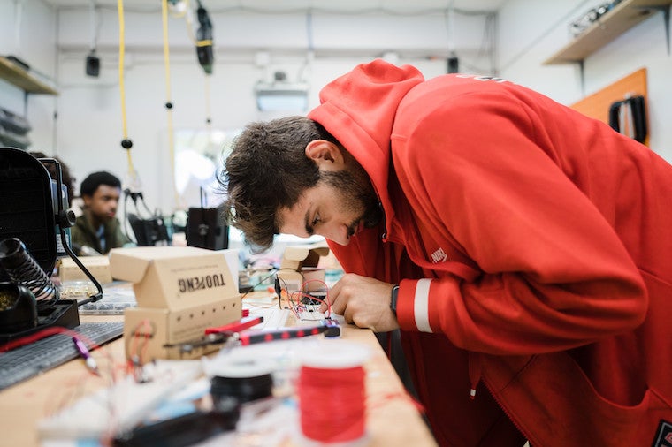 Person soldering wire