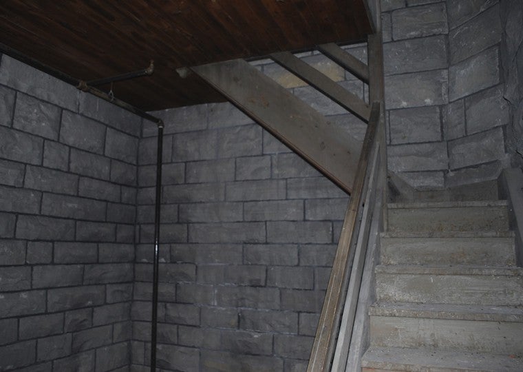 Stone staircase next to wooden handrails