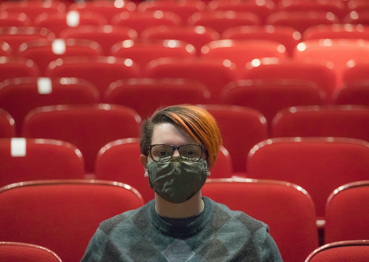 Ashton Doll seated in a theater.