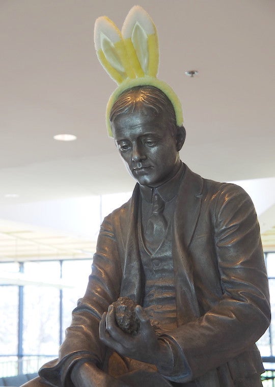 A statue of a man wearing rabbit ears.