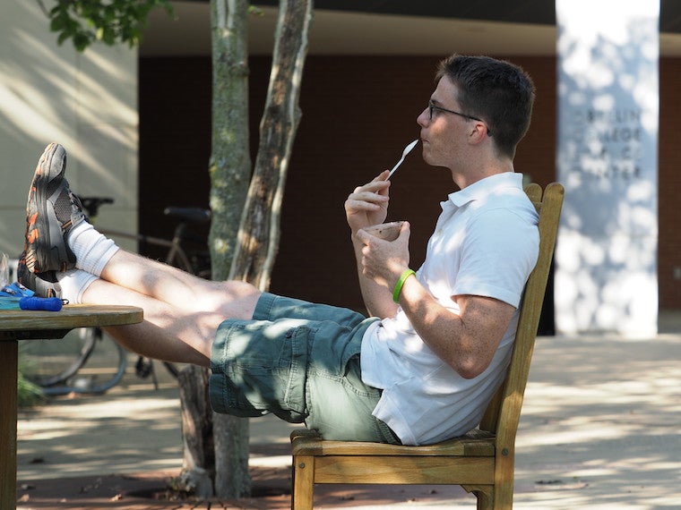 A male student enjoys a sundae.