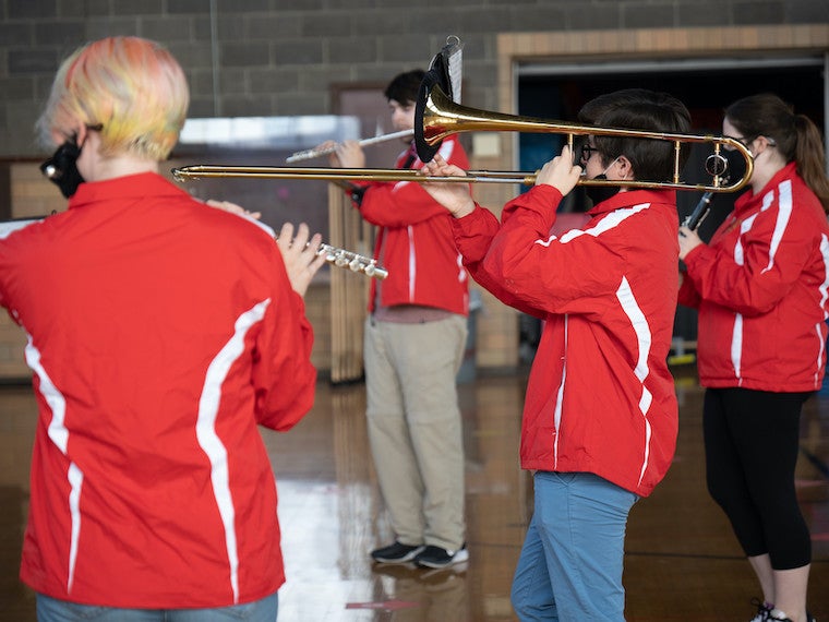 A small group of students play instruments.