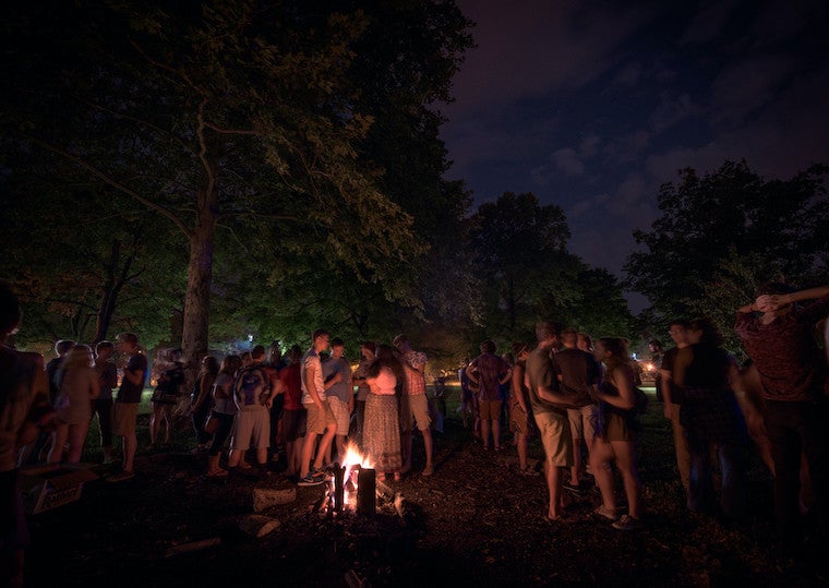 A large group of people at a bonfire. 
