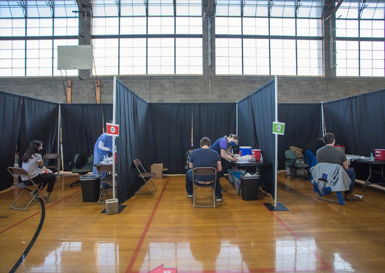 Students and nurses in three separate medical bays. 