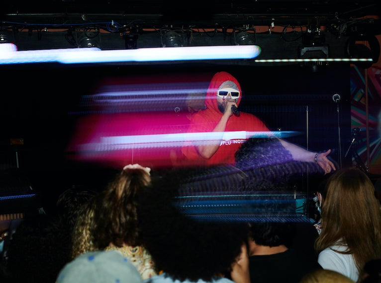 A DJ on performs at a nightclub.