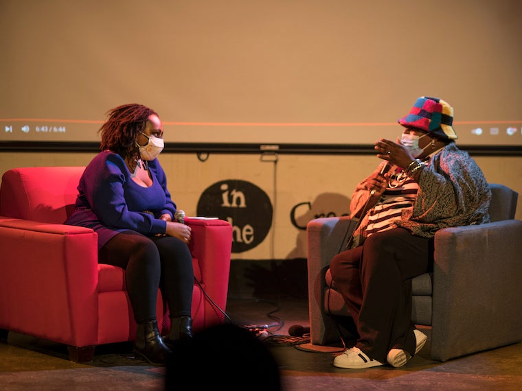 Two people talk on a stage.