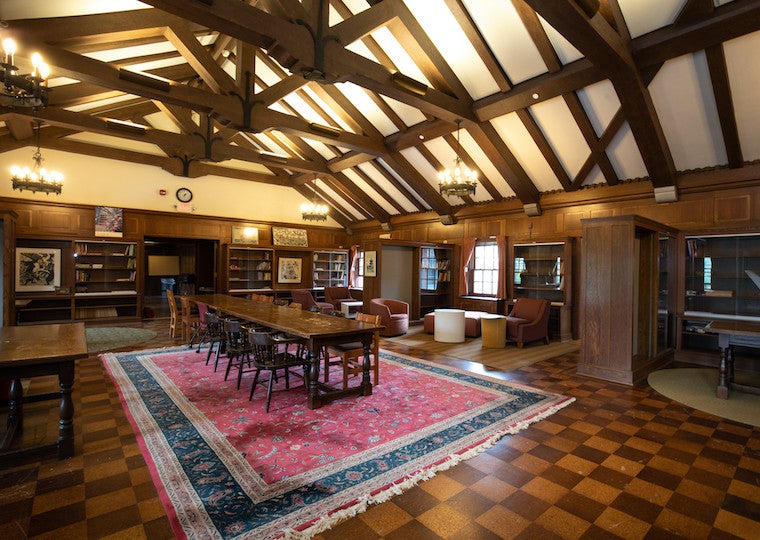 A dark wooden beamed library.