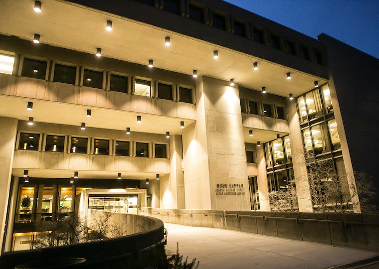 A night shot of a library with lots of lights.