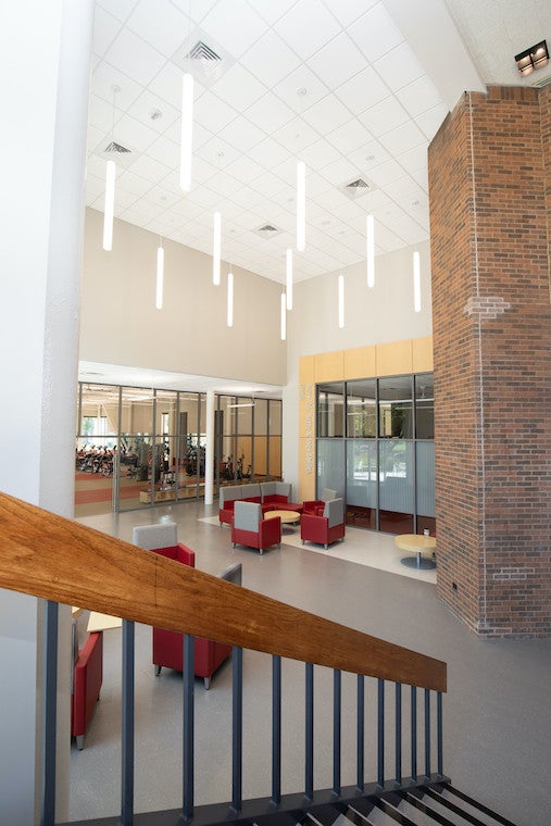 Long skinny lights hang in an open lounge area