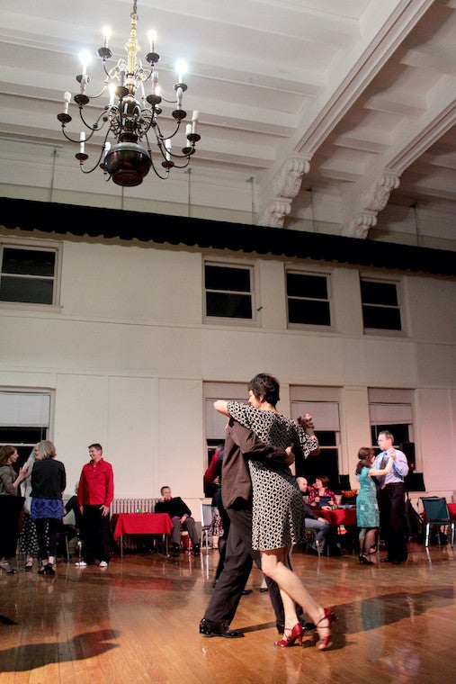 People dance in a large room