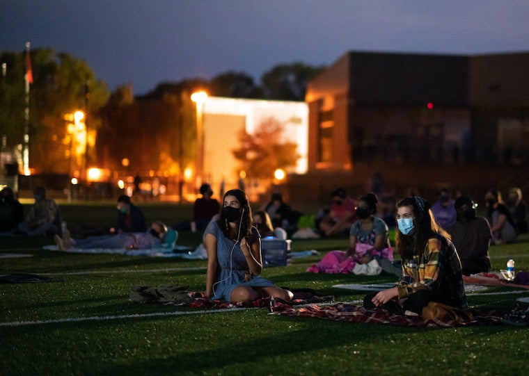 People watching a movie in a football field