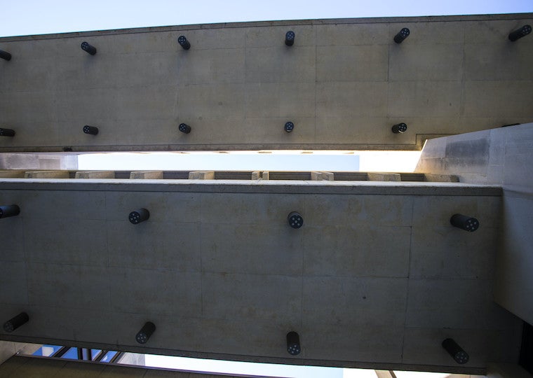 Two long concrete ceiling slabs with lights attached