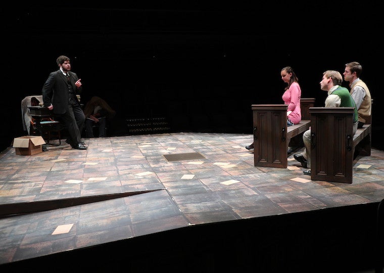 Four people on stage during a theater production.