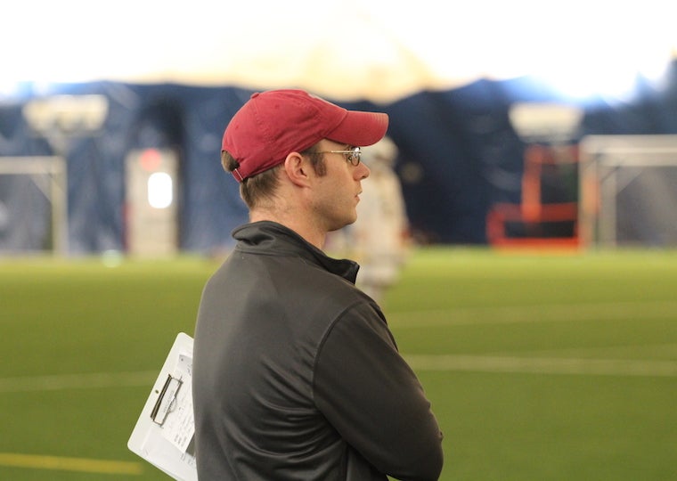 A man stands with a clipboard