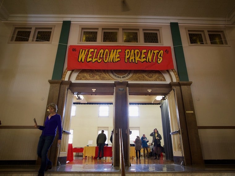 A large welcome sign hanging above double doors.