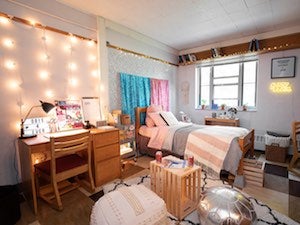 A bright, cheerfully decorated dorm room.