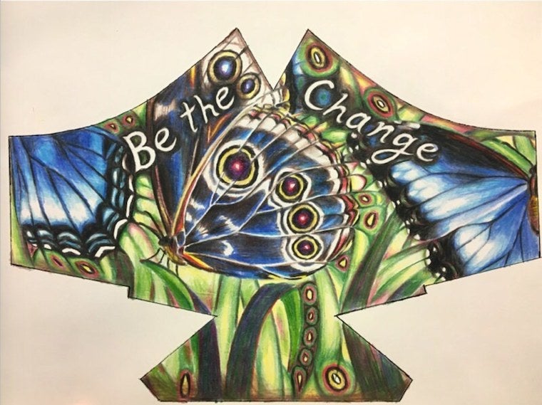 Mask design by Chloe Casdagli featuring blue butterflies. The text reads be the change.